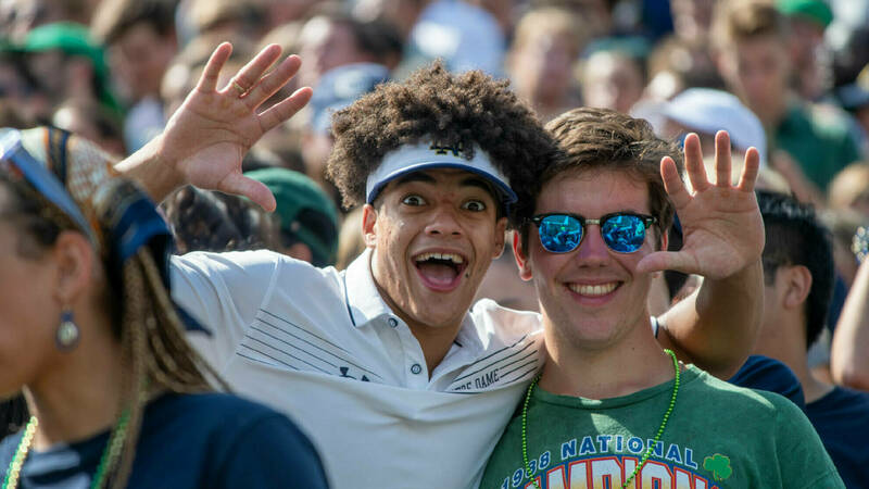 Students having fun and smiling at a home football game