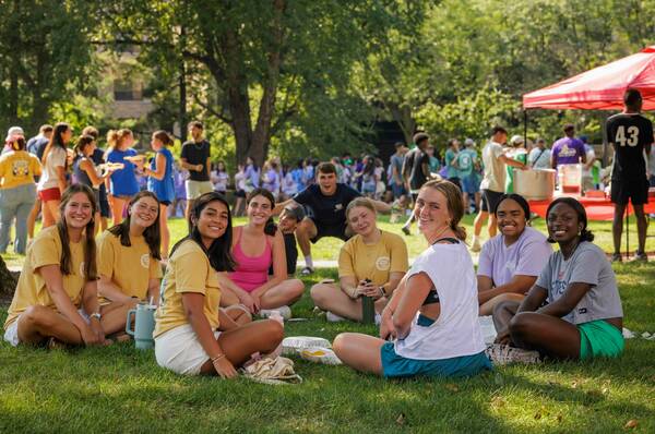 Female students gathered in a circle on the quad.